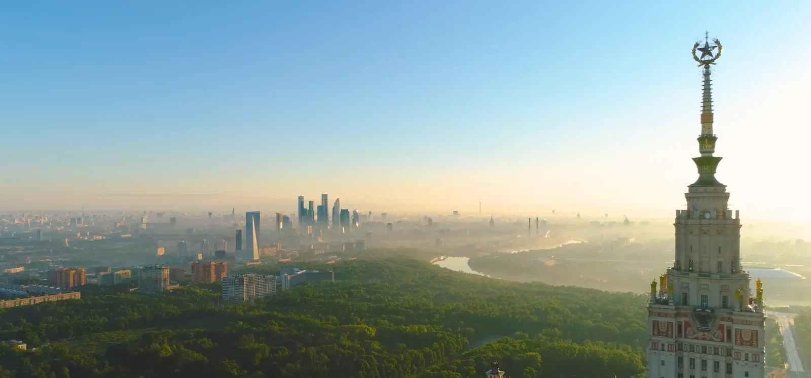 City skyline at dawn with a tall historic tower